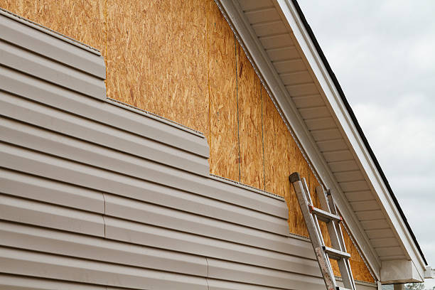 Professional Siding technician working in Port Jefferson Station, NY